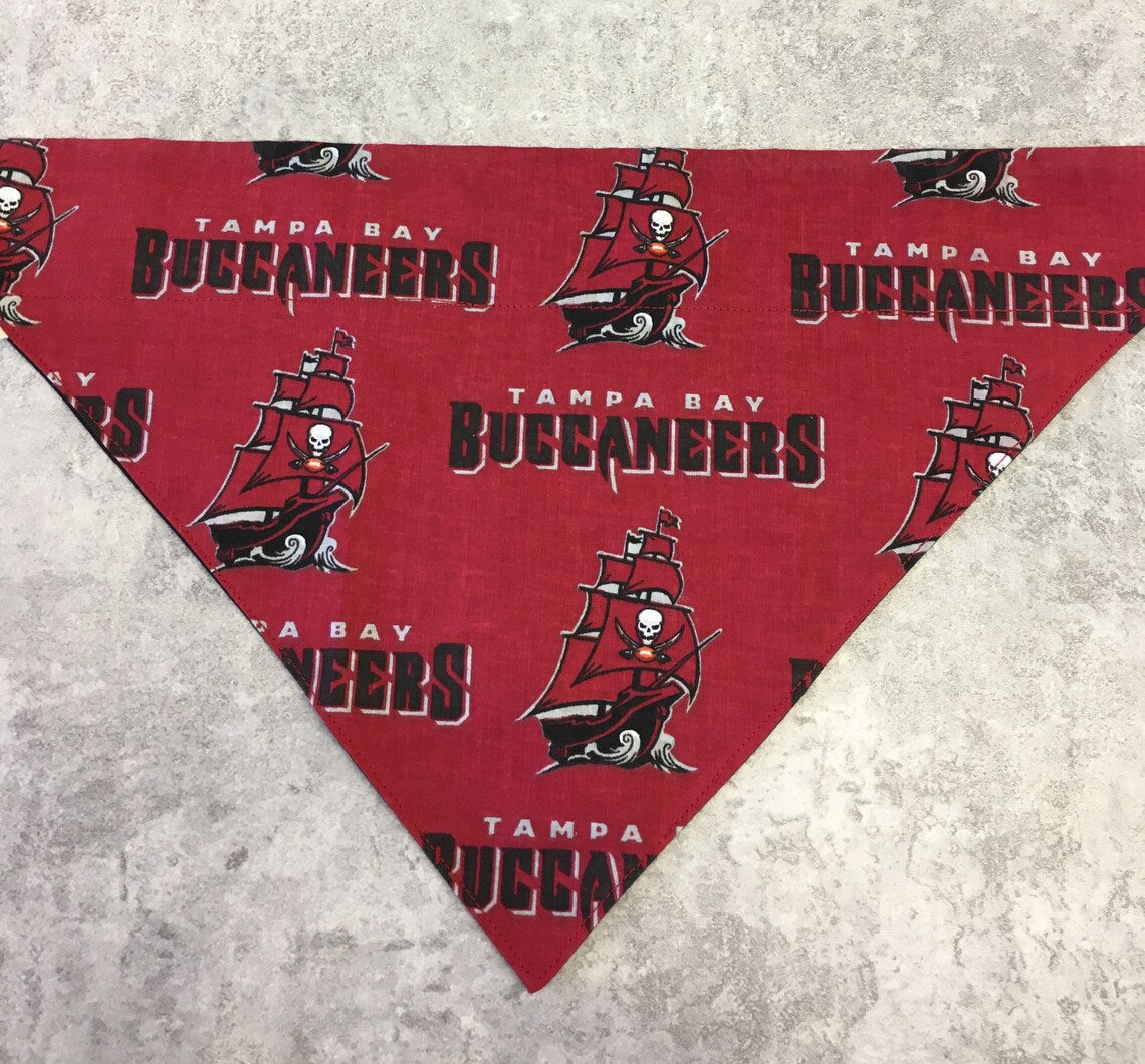 Red bandana with Tampa Bay Buccaneers logo on a gray surface