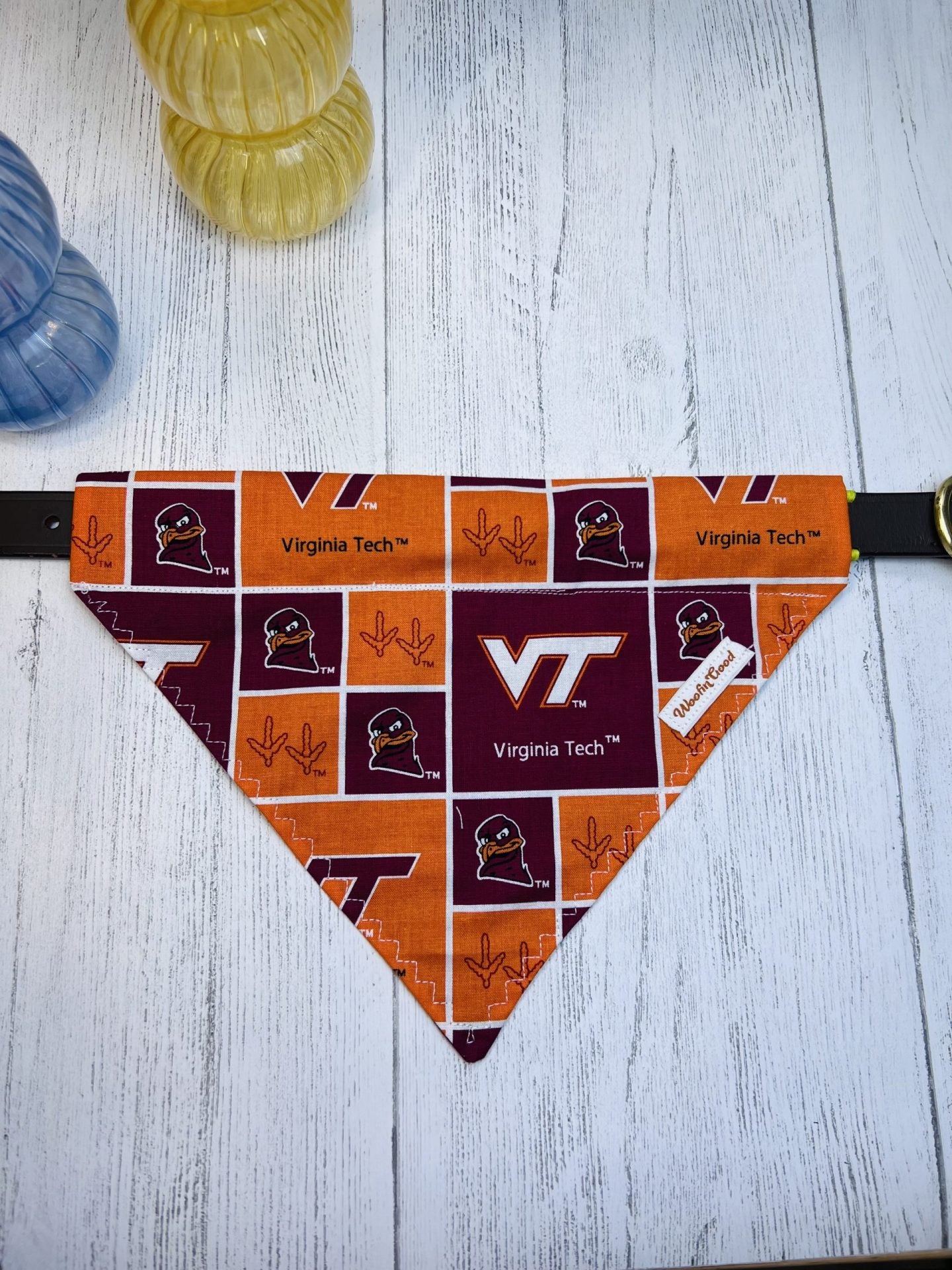 Dog bandana with Virginia Tech logo on a wooden surface
