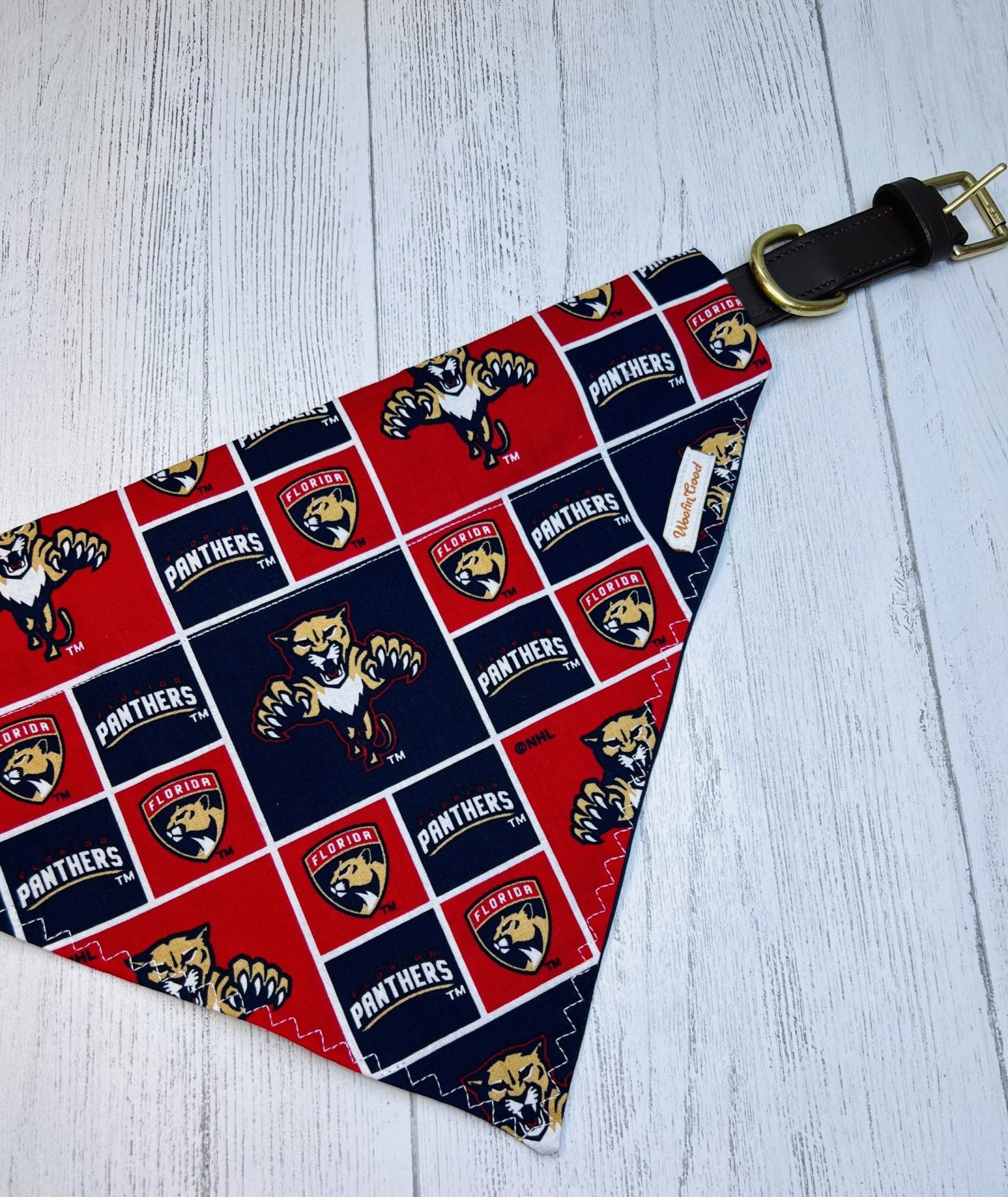 Dog bandana with Florida Panthers logo on a light gray surface