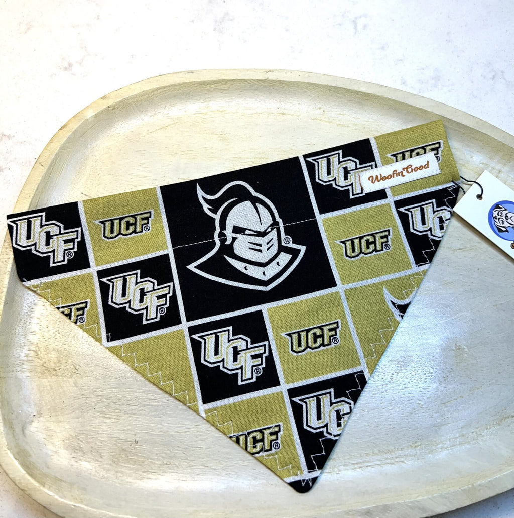UCF-themed bandana on a wooden tray with a white background