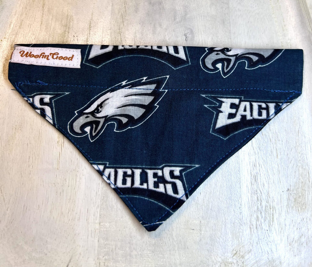 Dog bandana with Philadelphia Eagles logo on a light wooden surface